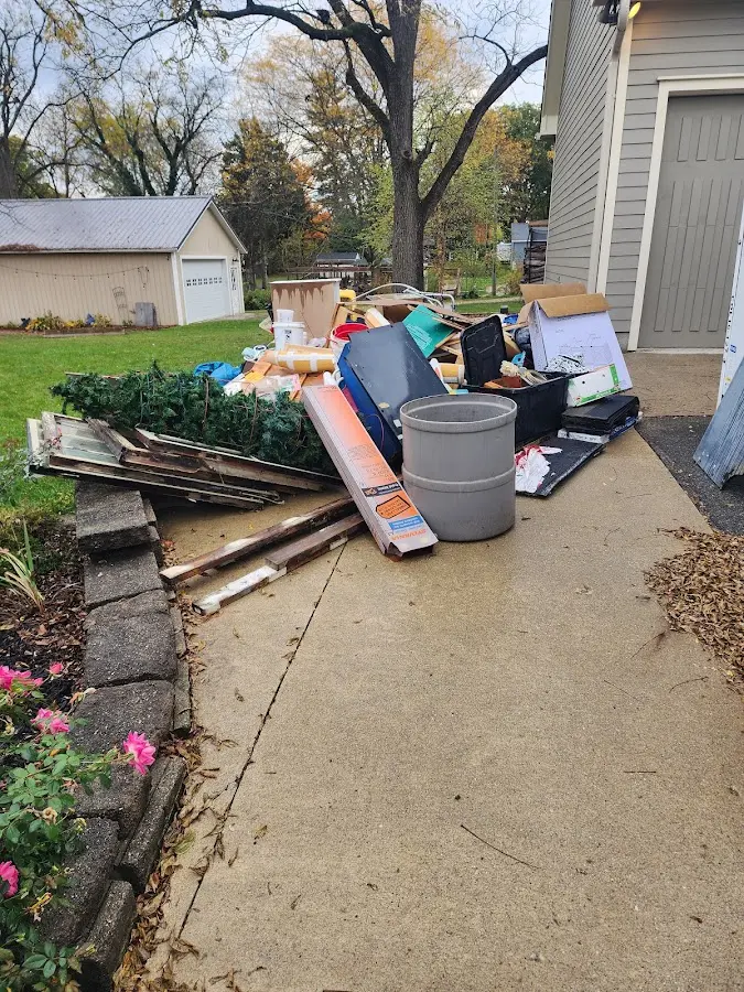 Dumpster being loaded with debris for 12 Yard Dumpster Rental in Logan